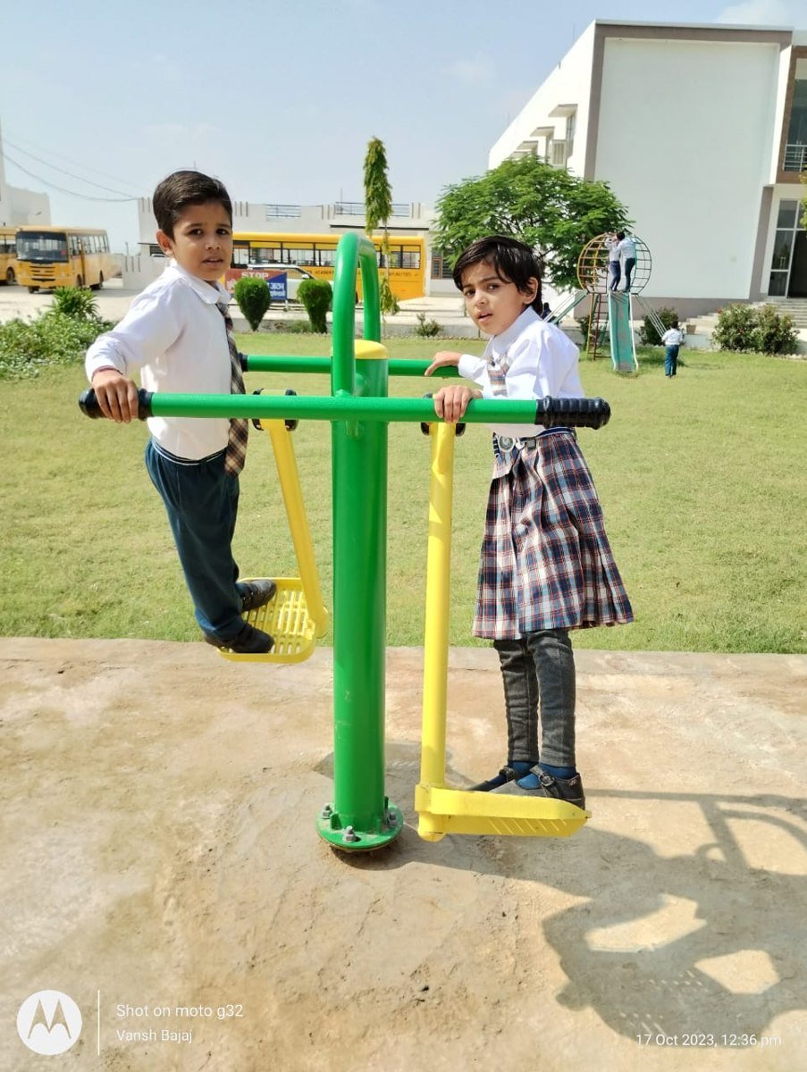Children using outdoor play equipment